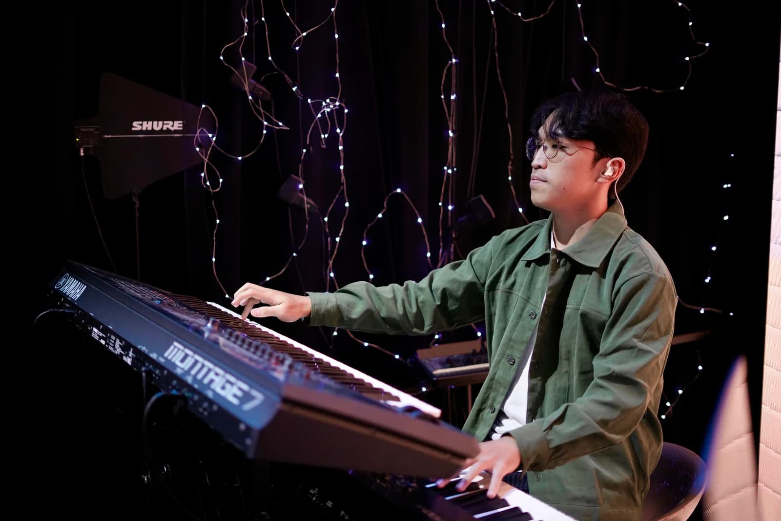 Keane Kenziro Yusack playing keyboard during a live performance