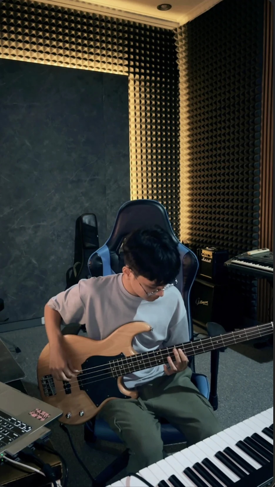 Student practicing bass in the studio