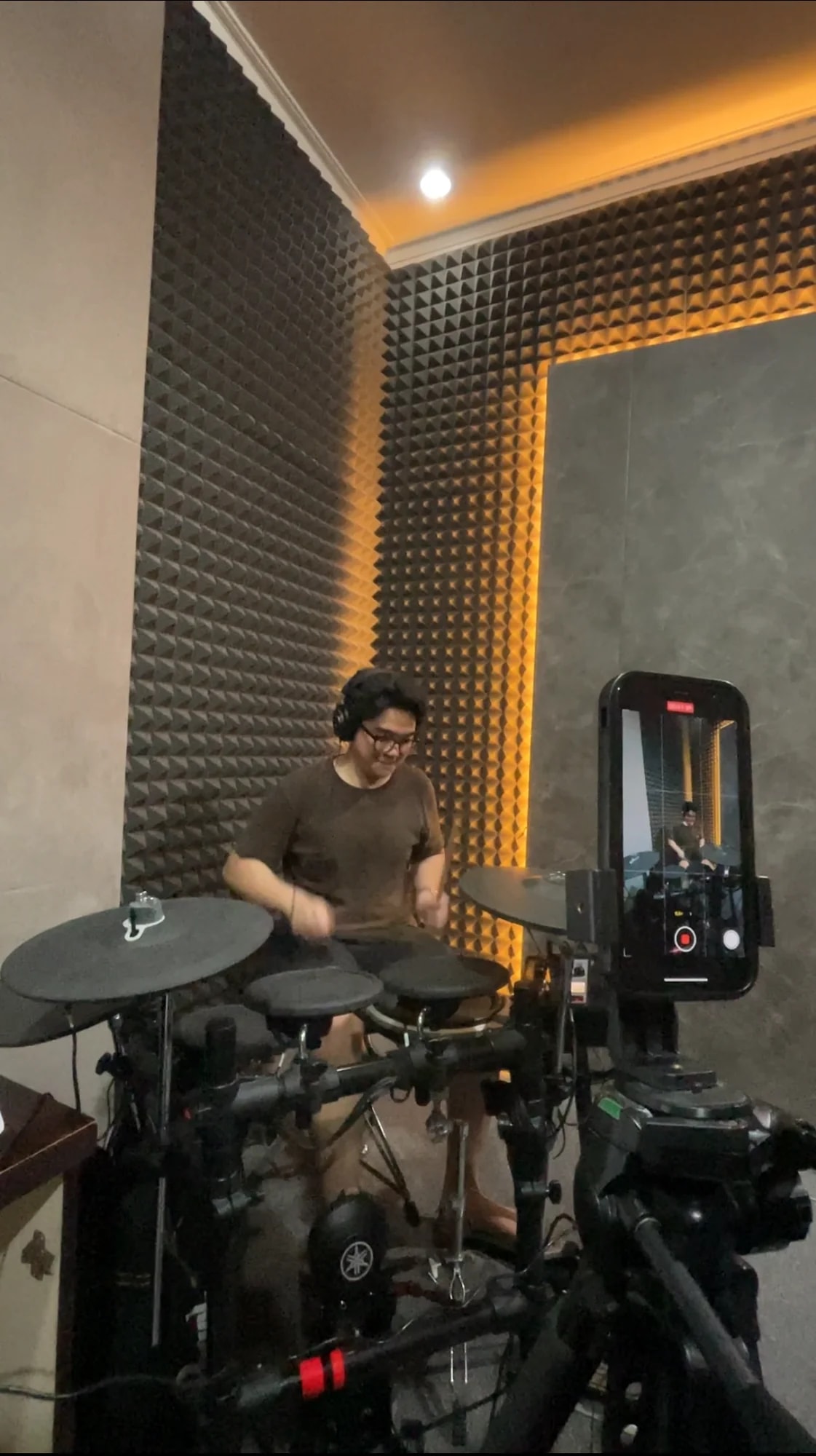 Student playing electronic drums in the studio